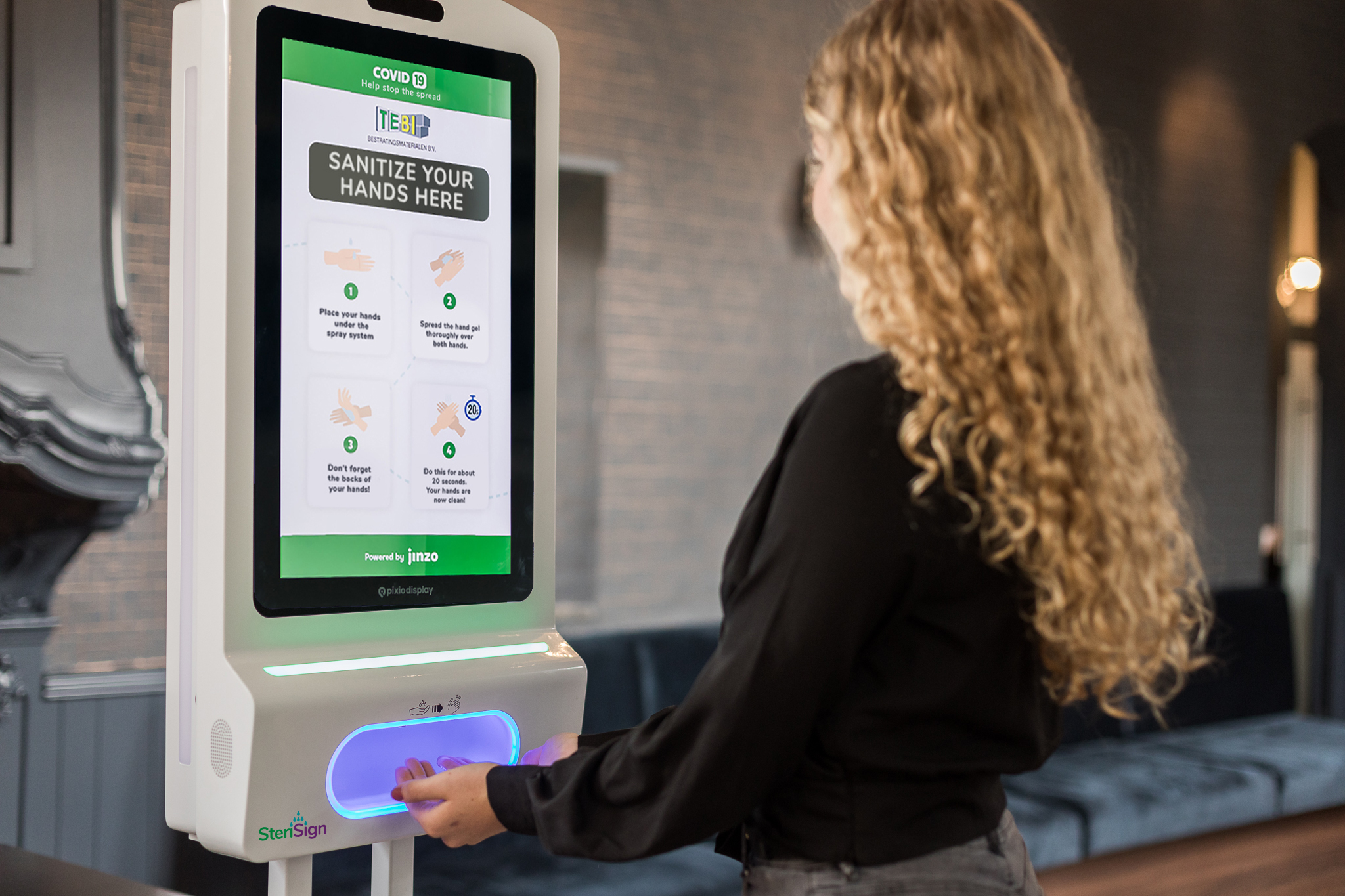 Customer using digital signage hand sanitizer unit